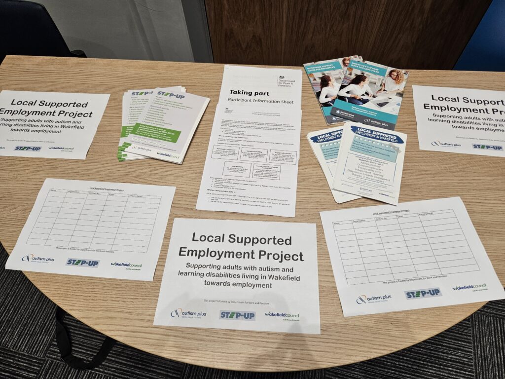 A picture looking down on a table with leaflets on for the Local Support Employment Project